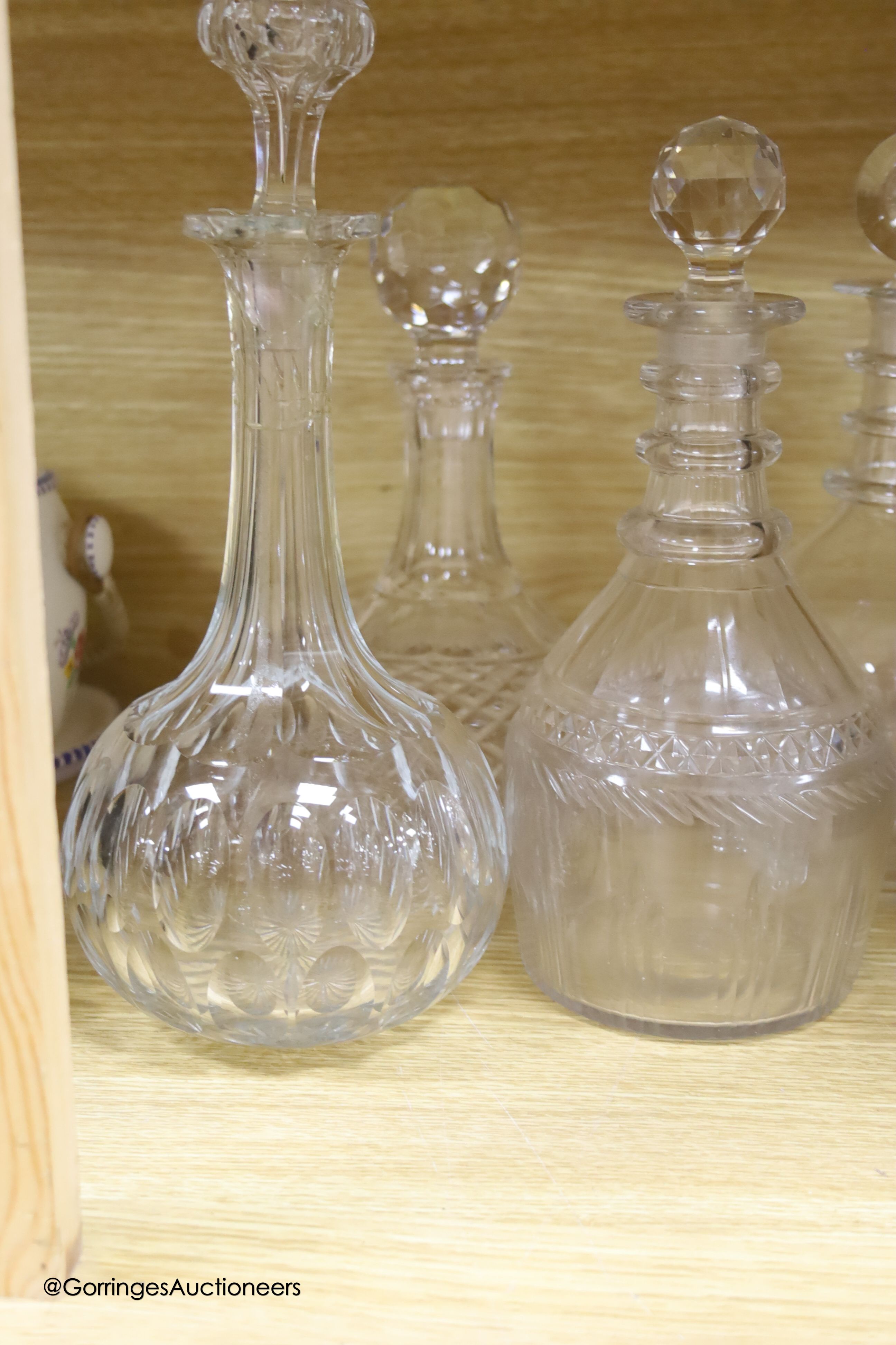 A collection of clear cut glass decanters